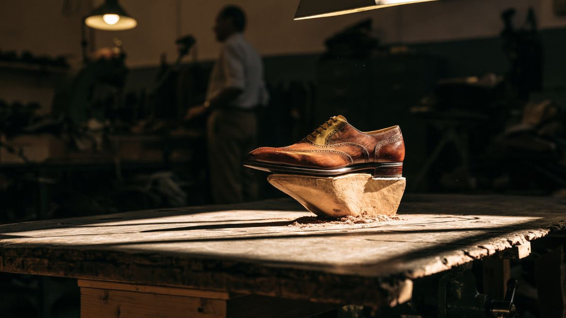 A hand-lasted leather shoe under workshop light, illustrating the craft tradition of a mid-sized heritage luxury house