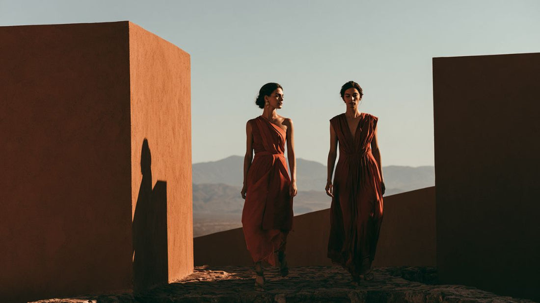 Architectural draped eveningwear in desert-toned palette, evoking heritage-craft independent design