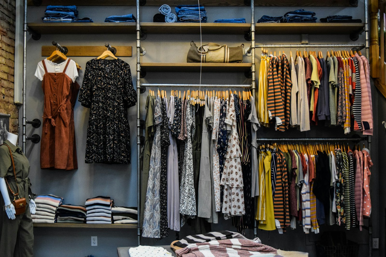 Curated vintage clothing rack in a sunlit secondhand shop