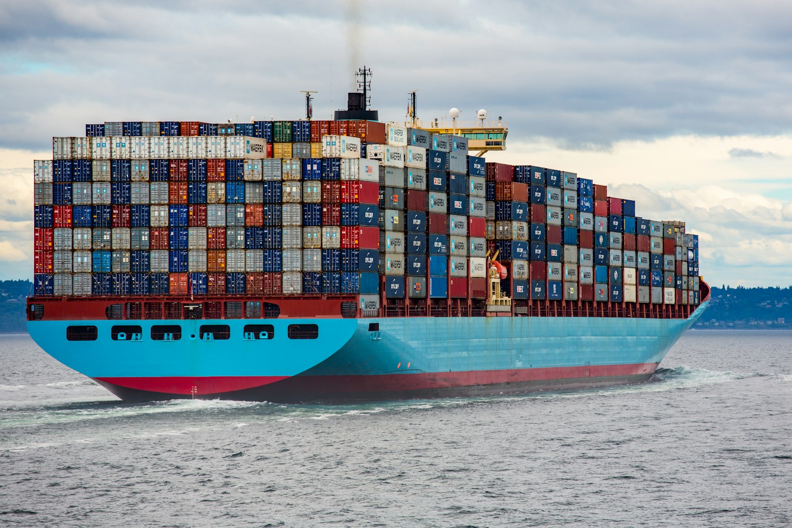 Shipping containers at a port representing global trade and tariff impacts on the fashion industry